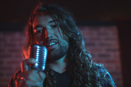 Close up of male singer performing in nightclubの写真素材
