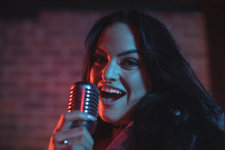 Close up portrait of female singer performing in nightclubの写真素材