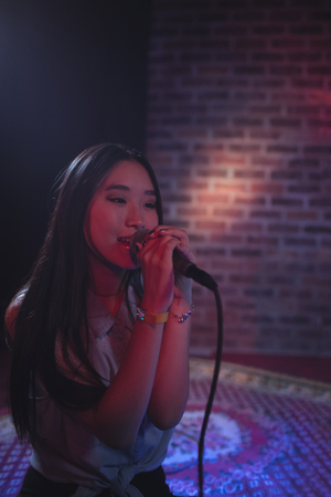 Close up of beautiful female singer performing at music concert