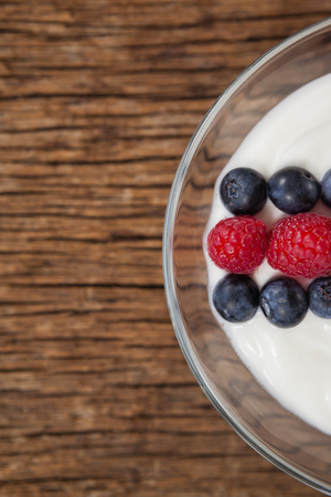 Close-up of fruit ice cream in bowl on wooden tableの写真素材