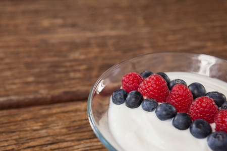 Close-up of fruit ice cream in bowl on wooden tableの写真素材