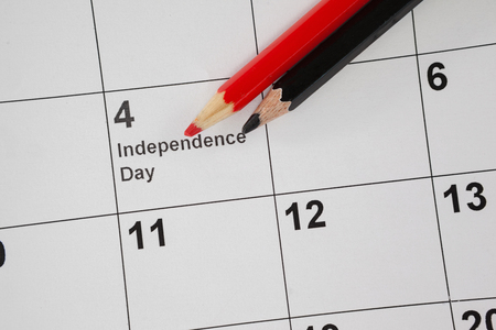 Close-up of colored pencil with fourth of July calendarの写真素材