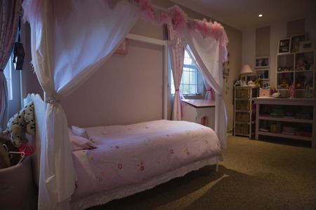 Neat bed in bedroom at homeの写真素材