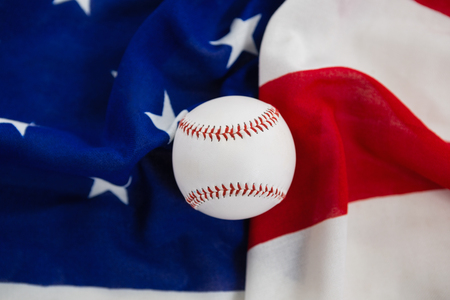 Close-up of baseball on an American flagの写真素材