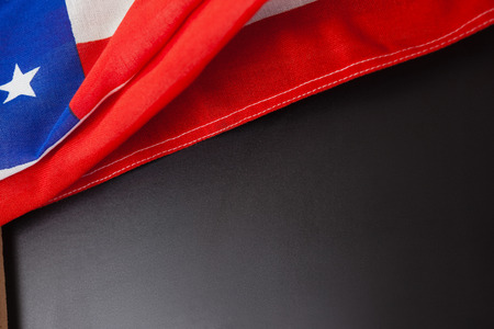 Close-up of American flag and slate on wooden tableの写真素材