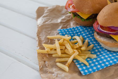Close-up of hamburger and french fries on wooden tableの写真素材