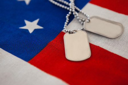 Full frame of dog tag on an American flagの写真素材