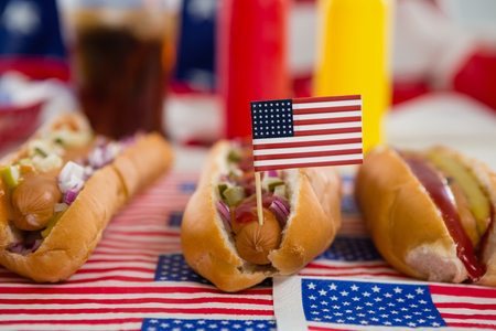 Close-up of American flag and hot dogs on wooden tableの写真素材
