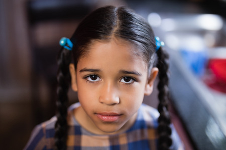 Portrait of cute girl in kitchen at homeの写真素材