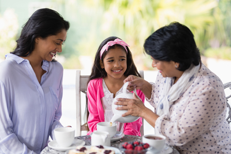 Happy multi-generation family having breakfast together at home