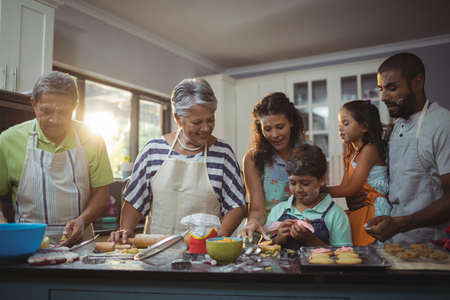 Happy family preparing dessert in kitchen at home