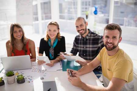 Portrait of business executives smiling in office
