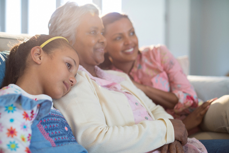 Happy family relaxing on sofa in living room at homeの写真素材
