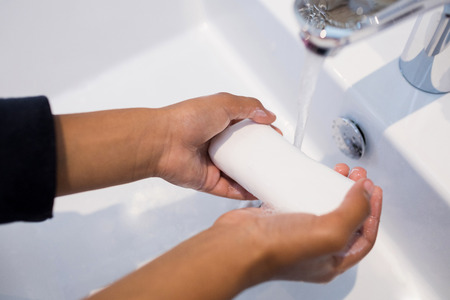 Close-up of girl washing hands in bathroom sink at home
