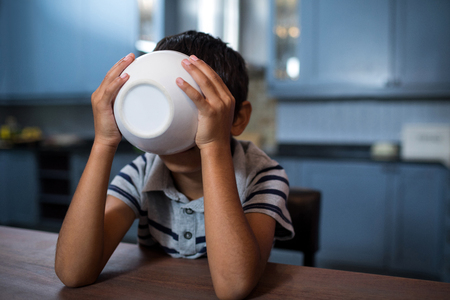Close up of boy having breakfast at tableの写真素材