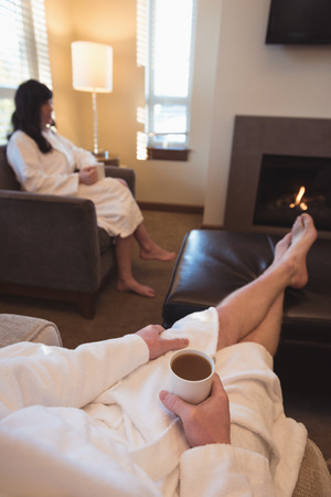Couple having coffee in the living room at homeの写真素材