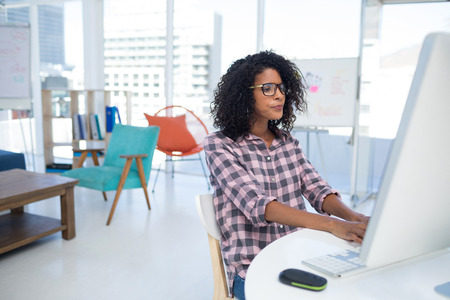 Female executive working on computer at desk in the officeの写真素材