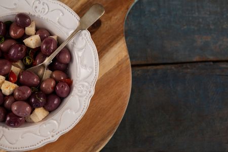 Cropped image of black olives served in plate on tray at tableの写真素材