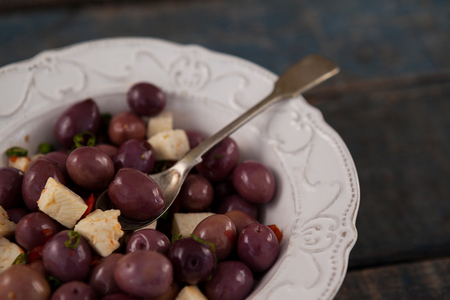Cropped image of black olives served in plate on tableの写真素材