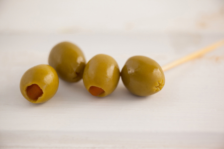 Close up of green olives on wooden tableの写真素材