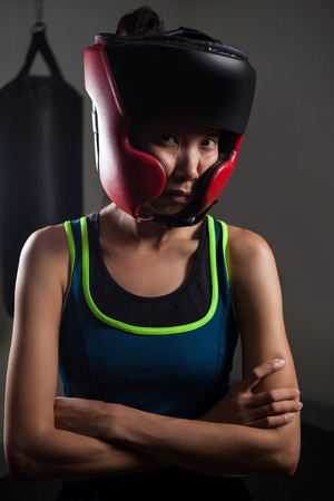 Determined woman wearing headgear during boxing in fitness studioの写真素材