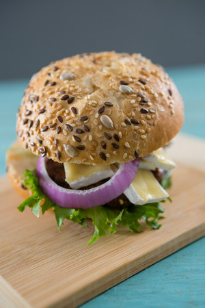 Close up of burger with cottage cheese on cutting boardの写真素材