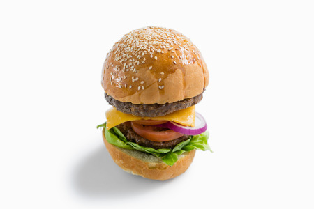 High anlge view of hamburger with vegetables and cheese against white backgroundの写真素材