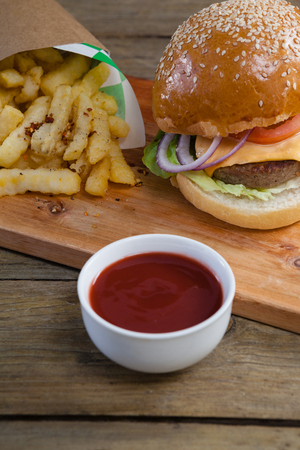 Close-up of hamburger, french fries and tomato sauce on tableの写真素材