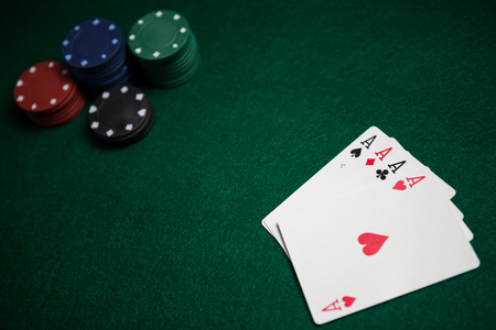 Playing cards and casino chips on poker table in casinoの写真素材