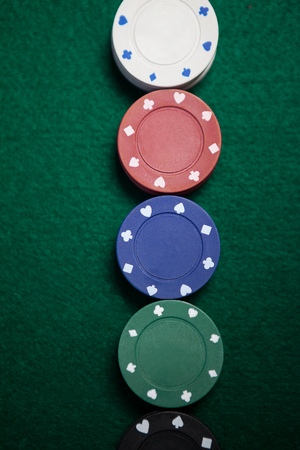 Close-up of casino chips arranged on poker table