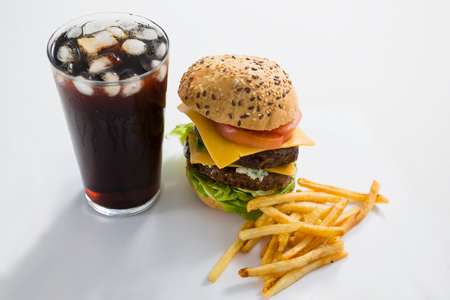Cheeseburger and drink with French fries on white backgroundの写真素材