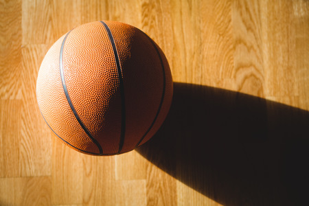 Close up of basketball on hardwood floorの写真素材