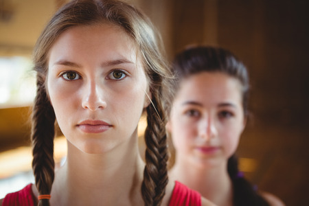 Close up of portrait female basketball player with friend in backgroundの写真素材