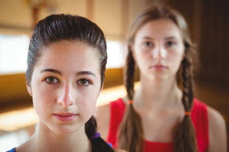 Close up of portrait female basketball player with friend in backgroundの写真素材