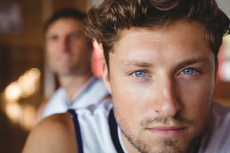 Close up portrait of male basketball player with friend in backgroundの写真素材
