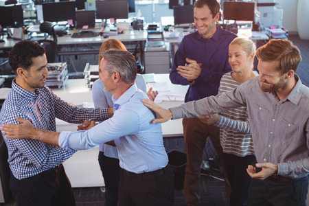 Happy business people interacting with each other at office