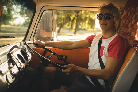 Smiling man wearing sunglasses while driving camper vanの写真素材