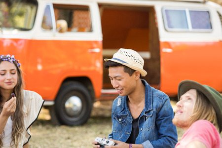Friends enjoying picnic while relaxing on field