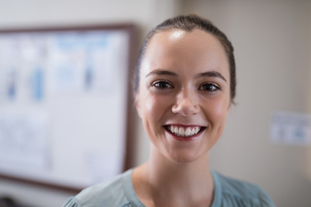 Close-up portrait of smiling young female therapist at hospitalの写真素材