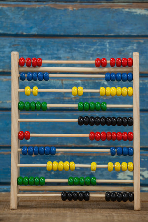 Abbacus game against blue wooden background