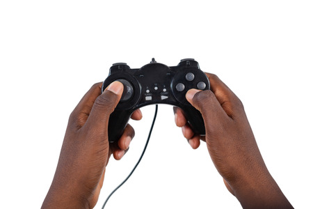 Close-up of mans hand playing video game against white background