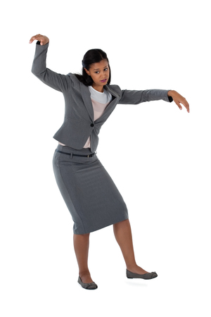 Excited businesswoman dancing against white backgroundの写真素材
