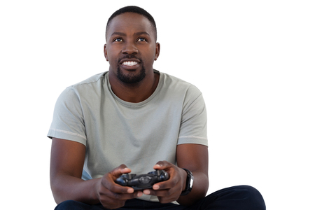 Smiling man playing video game against white backgroundの写真素材
