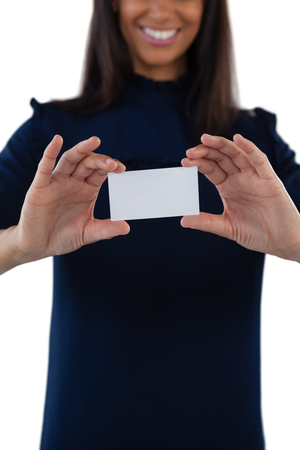 Mid section of female executive holding a blank business cardの写真素材