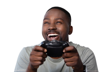 Close-up of smiling man playing video game against white backgroundの写真素材