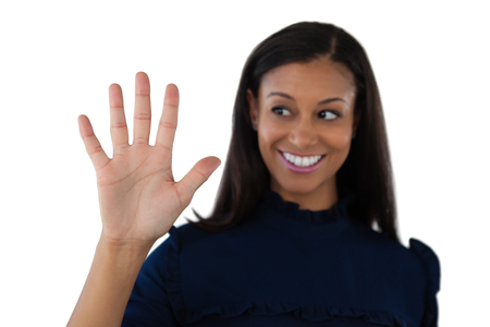 Female executive showing stop sign against white backgroundの写真素材