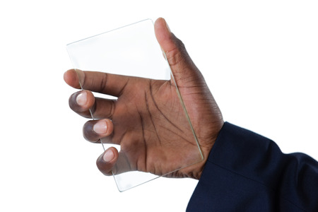 Close-up of businessman holding a glass smartphoneの写真素材