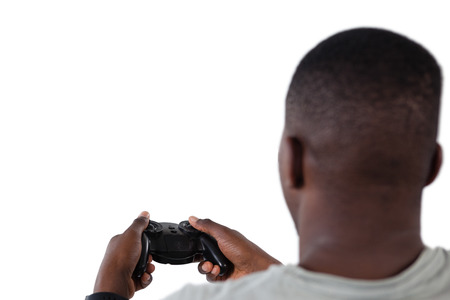 Close-up of man playing video game against white backgroundの写真素材