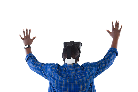 Rear view of man gesturing while using virtual reality headsetの写真素材