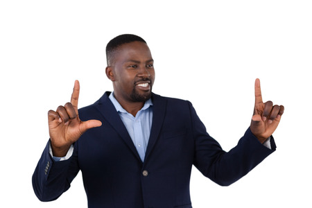 Smiling businessman forming a finger frame against white backgroundの写真素材